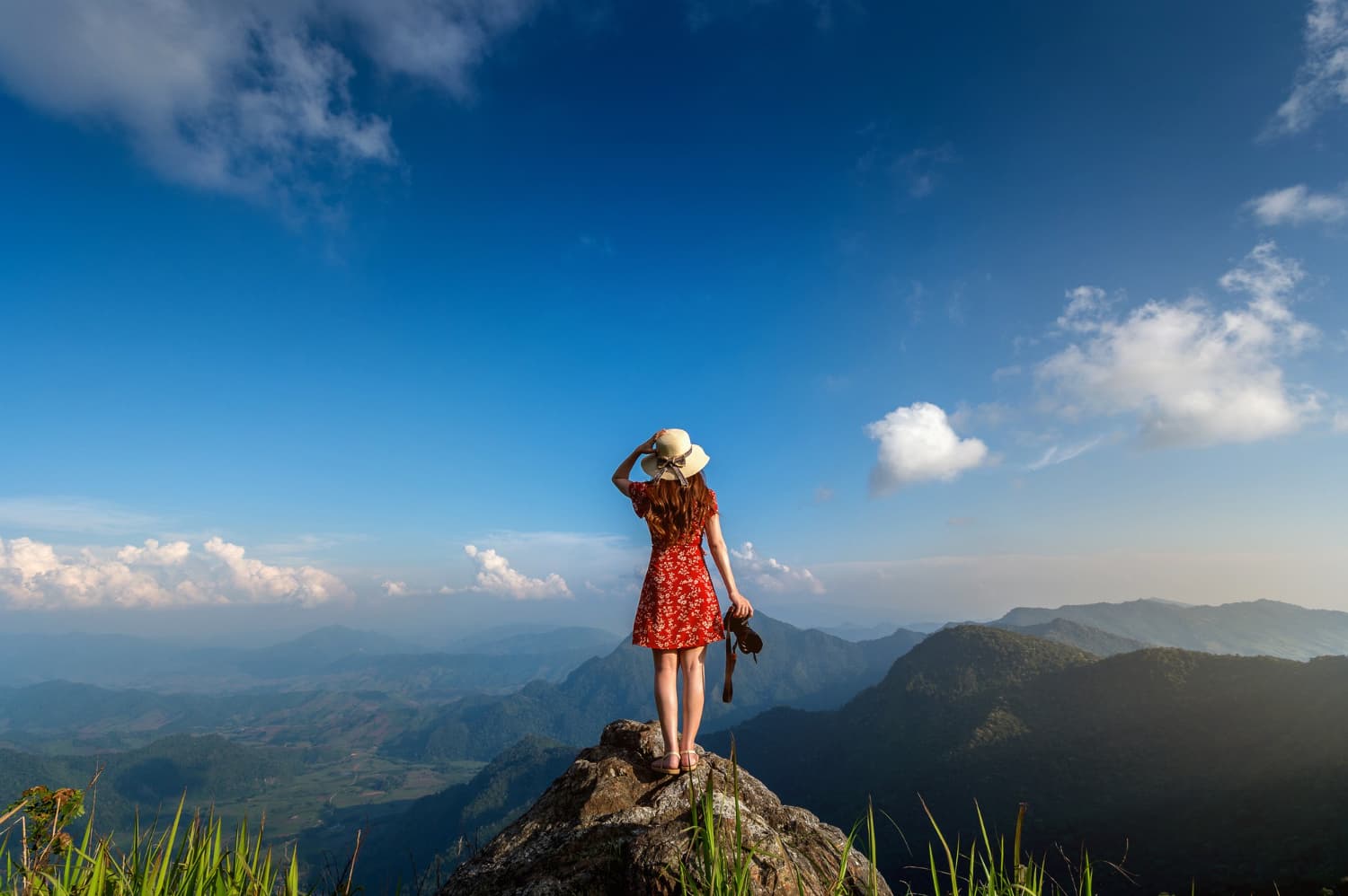 Woman in red dress on a cliff